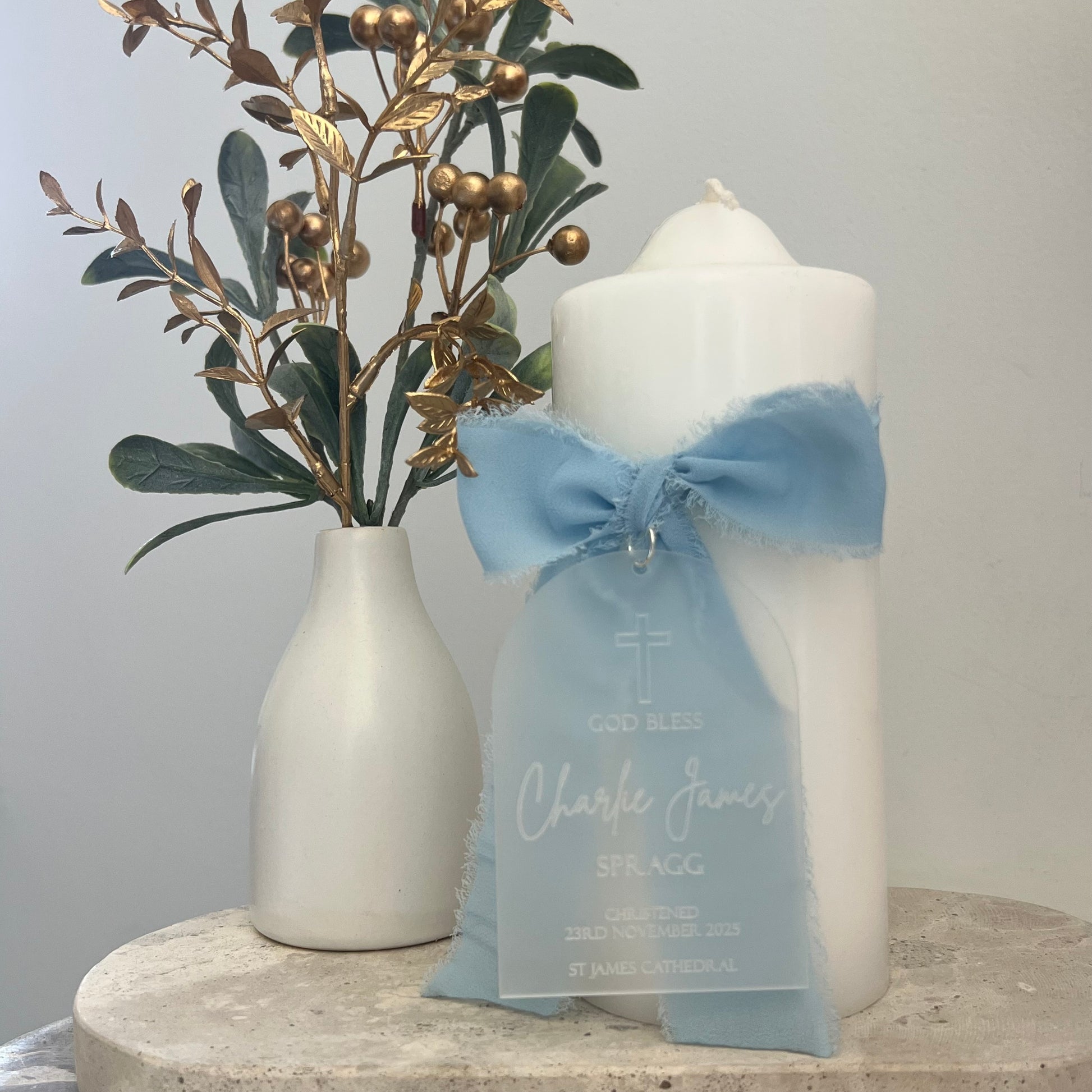 Christening Candle with a blue bow and personalised frosted tag with details