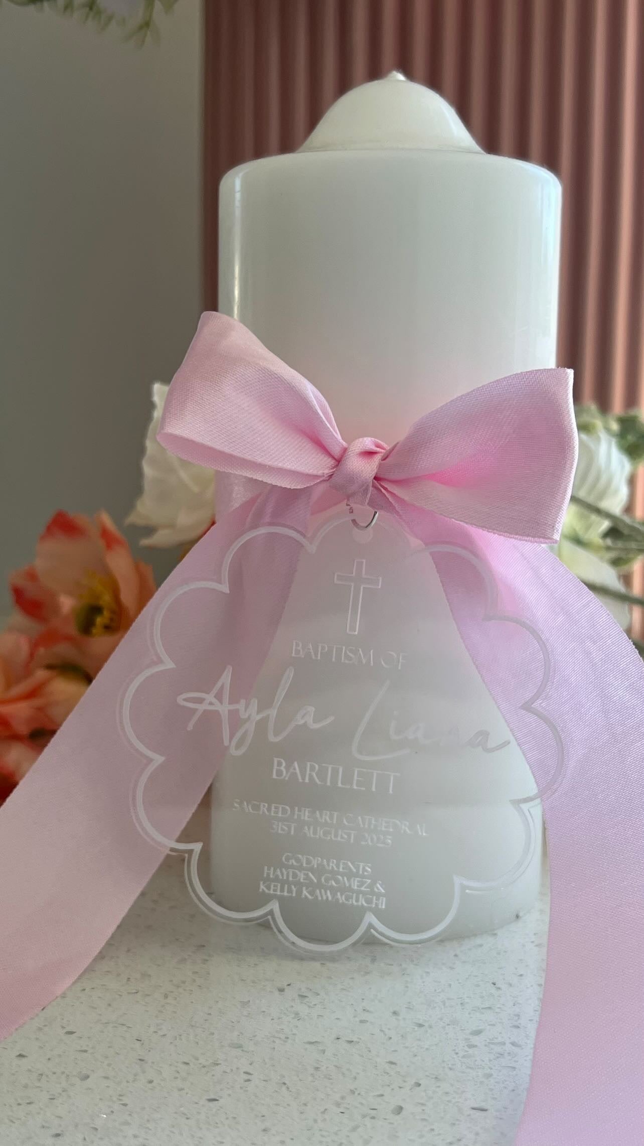 Christening Candle with a pink bow and personalised clear tag with details