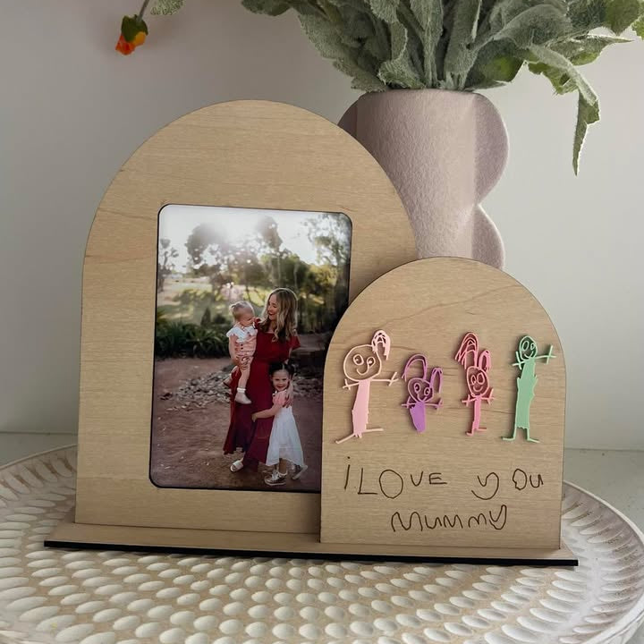 A wooden photo frame with a semi-circular shape, featuring a photo of a mother and child, and a custom decorative plaque with the text 'I love you Mummy' along with colorful, cut-out shapes representing a family. Personalised how you want it