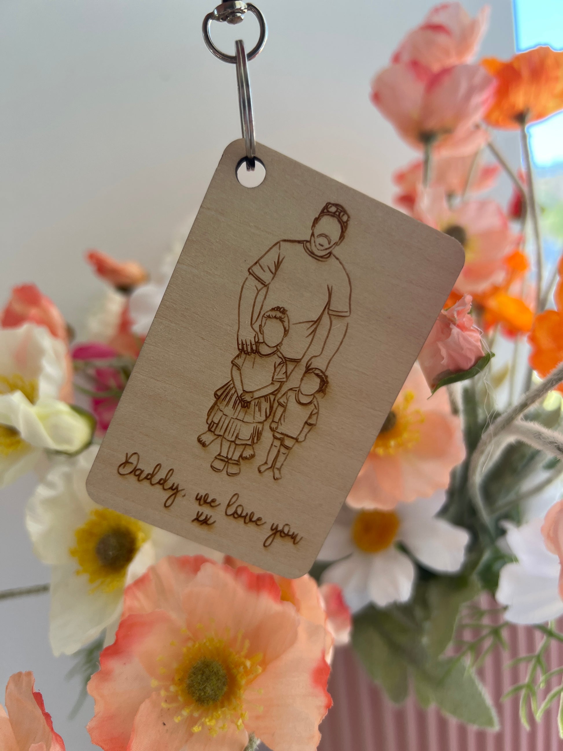 Wooden keychain with engraved design and 'Daddy, we love you' text, personalised