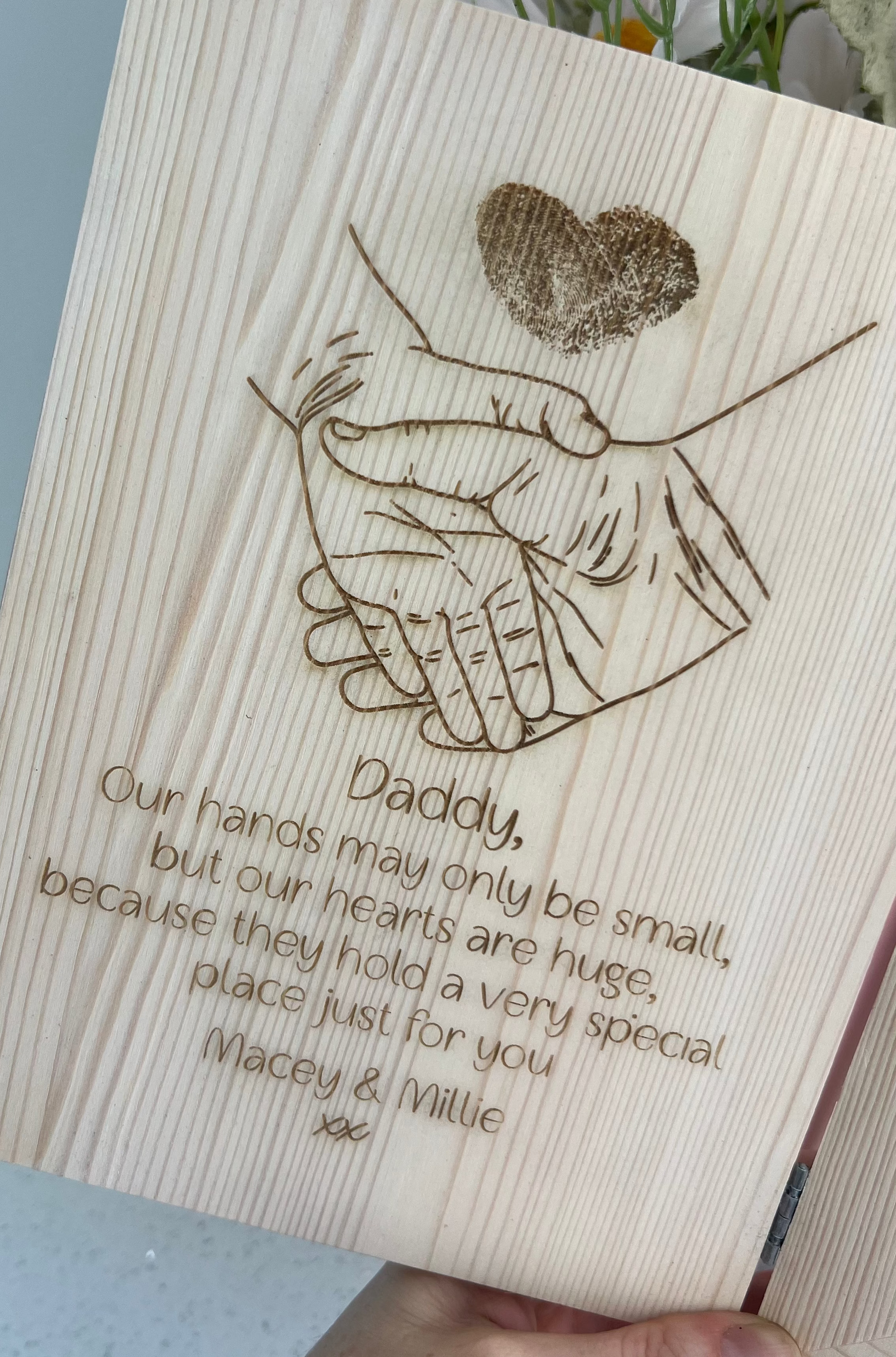 Wooden plaque with engraved hands holding a heart with personalised text