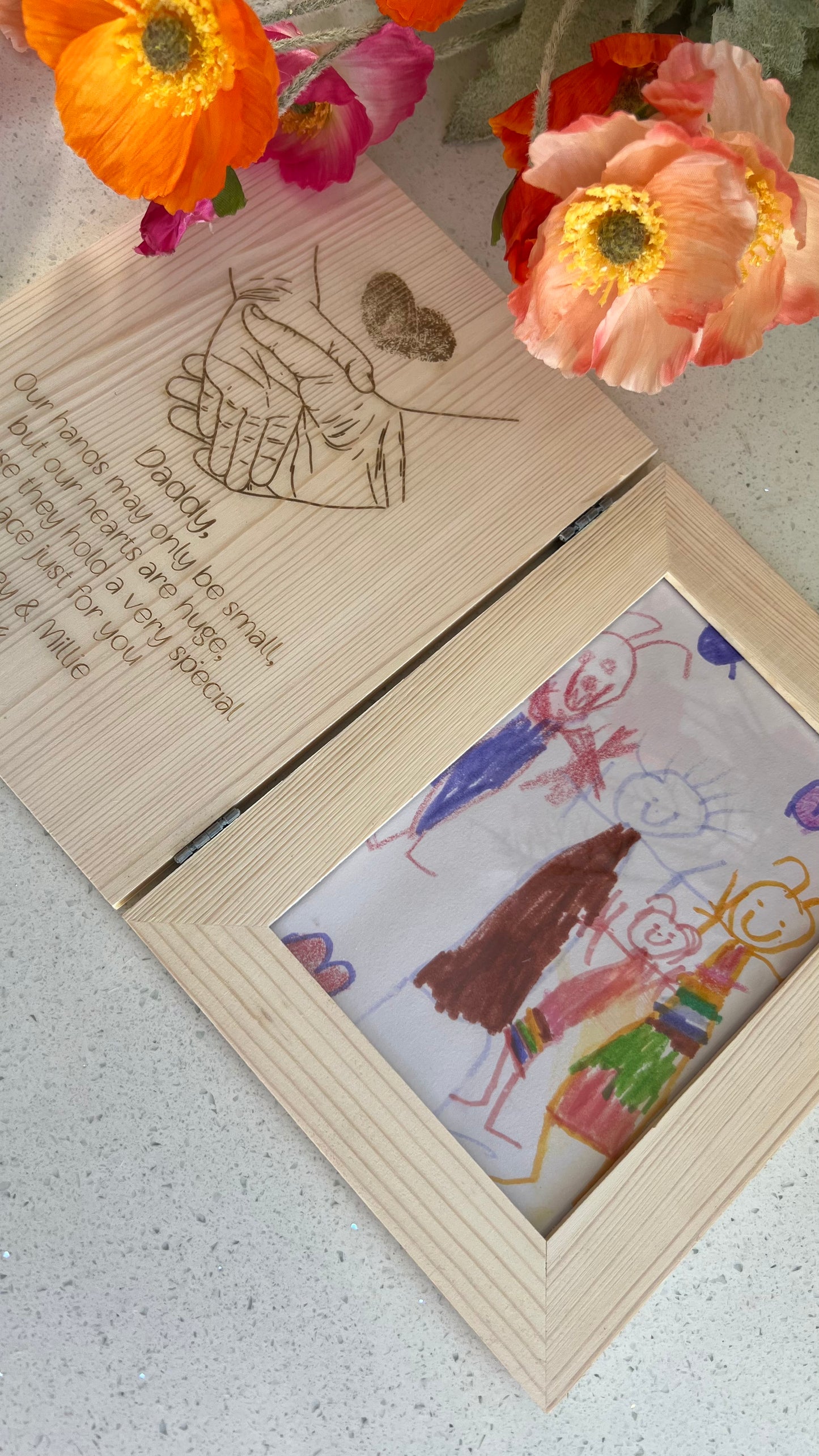 Wooden photo frame with a child's drawing inside