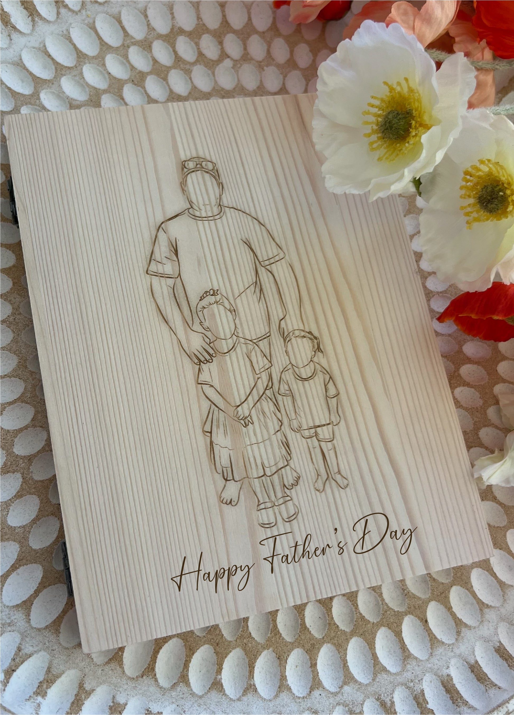 Wooden card with engraved illustration of a father and two children