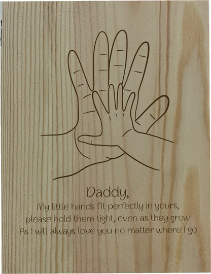 Wooden plaque with line drawing of two hands and a message on a wooden background