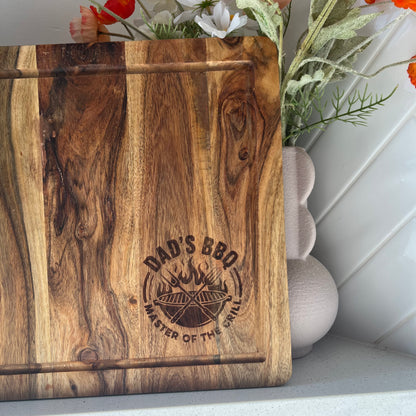 Wooden cutting board with 'Dad's BBQ Master of the Grill' engraving
