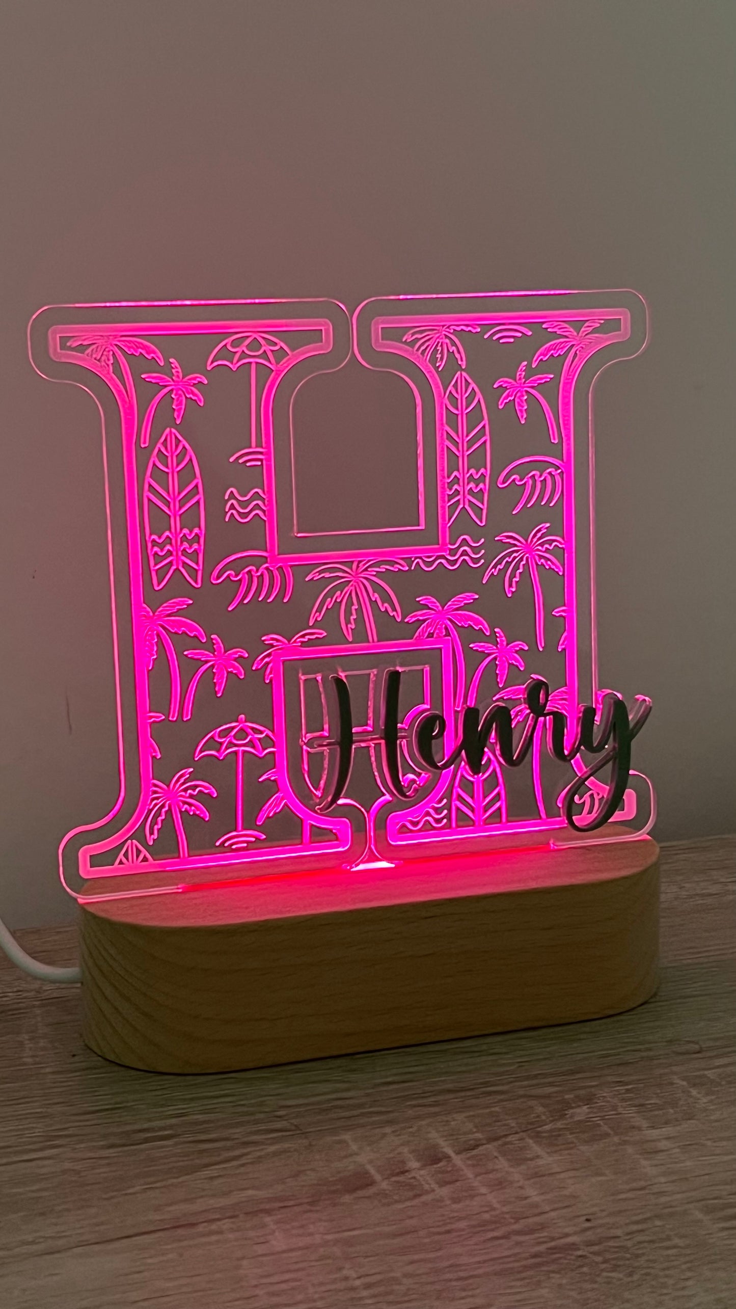 Decorative lamp with a letter with Palm trees and surf boards engraved in the background and an acrylic name on the front in a LED light base