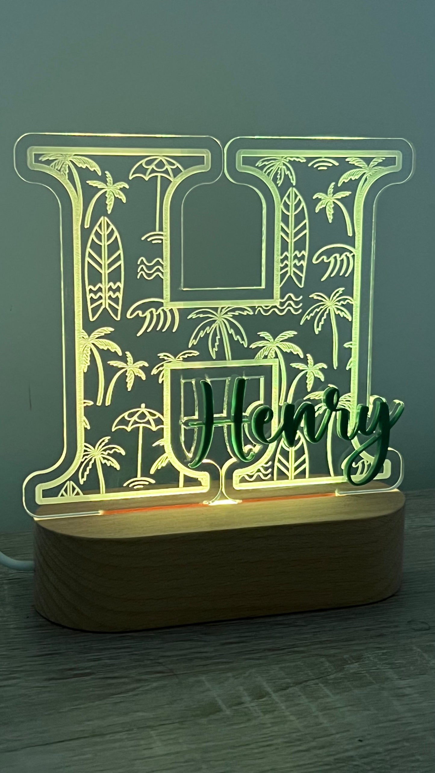Decorative lamp with a letter with Palm trees and surf boards engraved in the background and an acrylic name on the front in a LED Light base