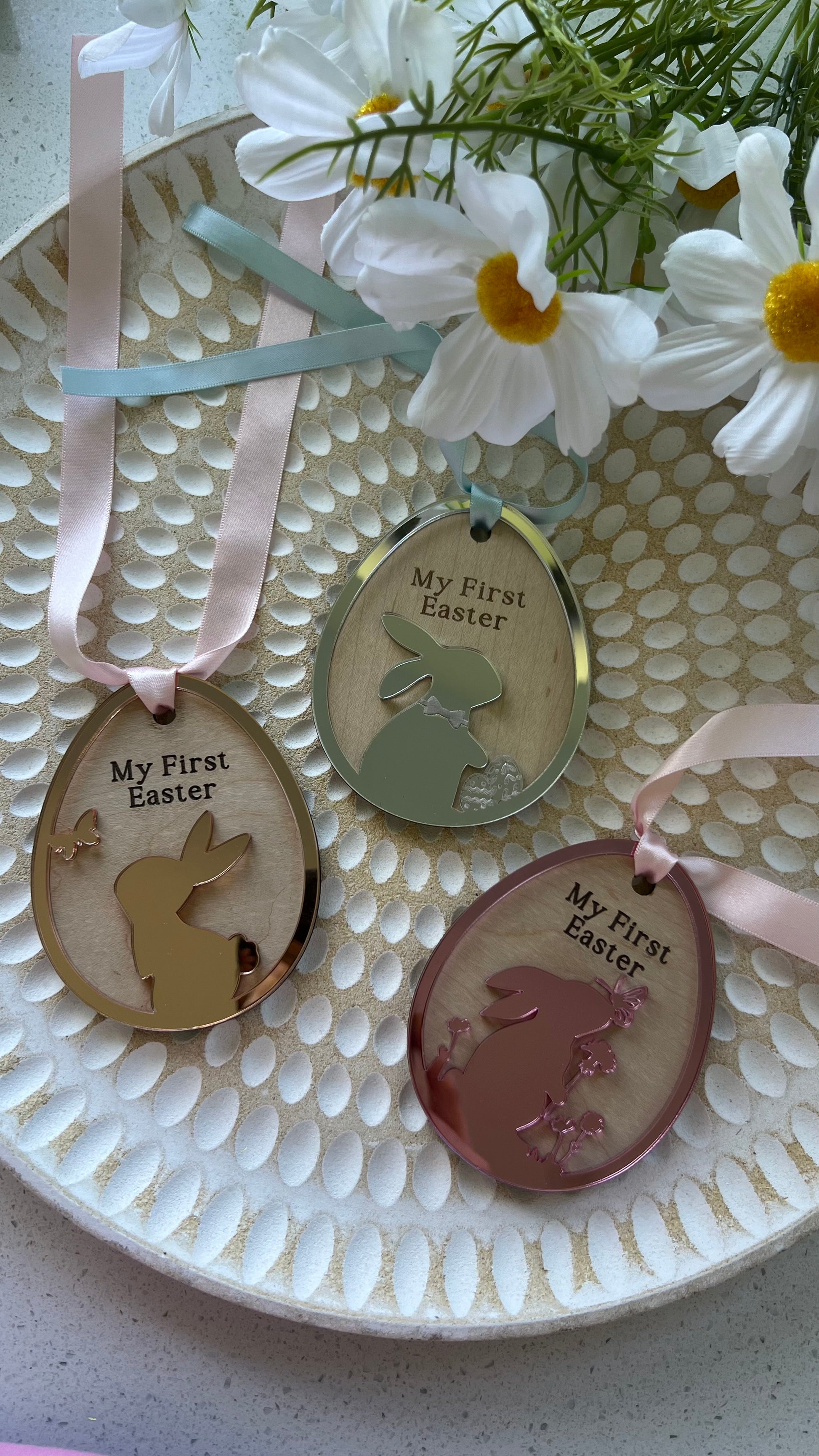 Personalized keepsake ornaments for Easter, featuring pastel colors mirror with ribbons, engraved with 'My First Easter' and customizable text.