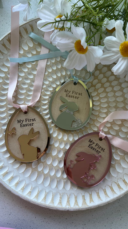Personalized keepsake ornaments for Easter, featuring pastel colors mirror with ribbons, engraved with 'My First Easter' and customizable text.
