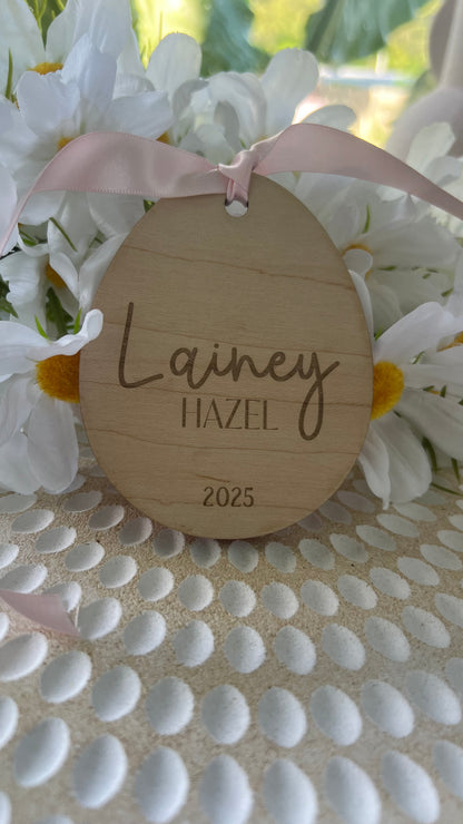 Personalized keepsake ornaments for Easter, featuring pastel colors with ribbons, engraved with customizable text.