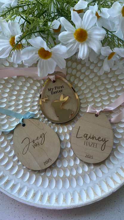 Personalized keepsake ornaments for Easter, featuring pastel colors mirror with ribbons, engraved with 'My First Easter' and customizable text.