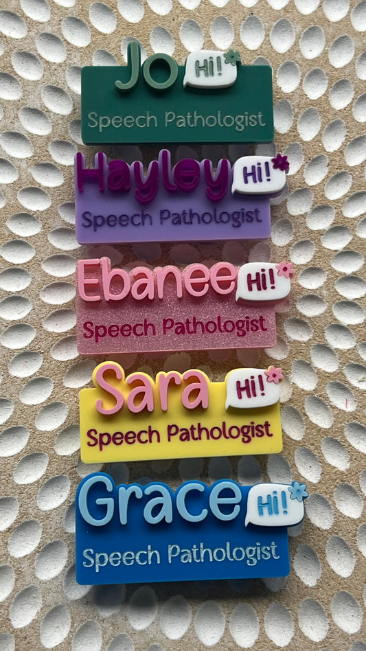 Set of colorful name tags for speech pathologists on a textured background