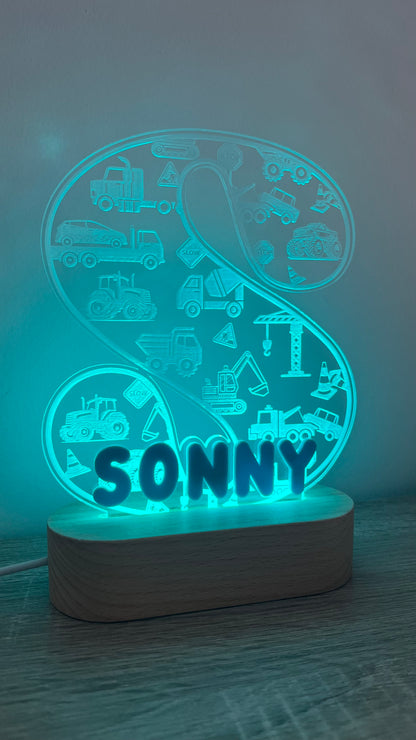 Decorative lamp with letter and name on it with engraved trucks on background