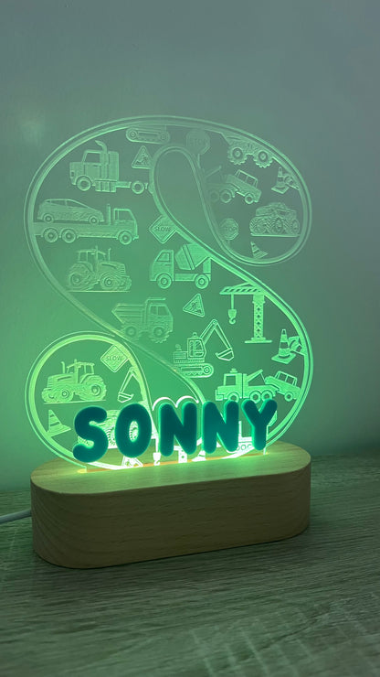 Decorative lamp with letter and name on it with engraved trucks on background